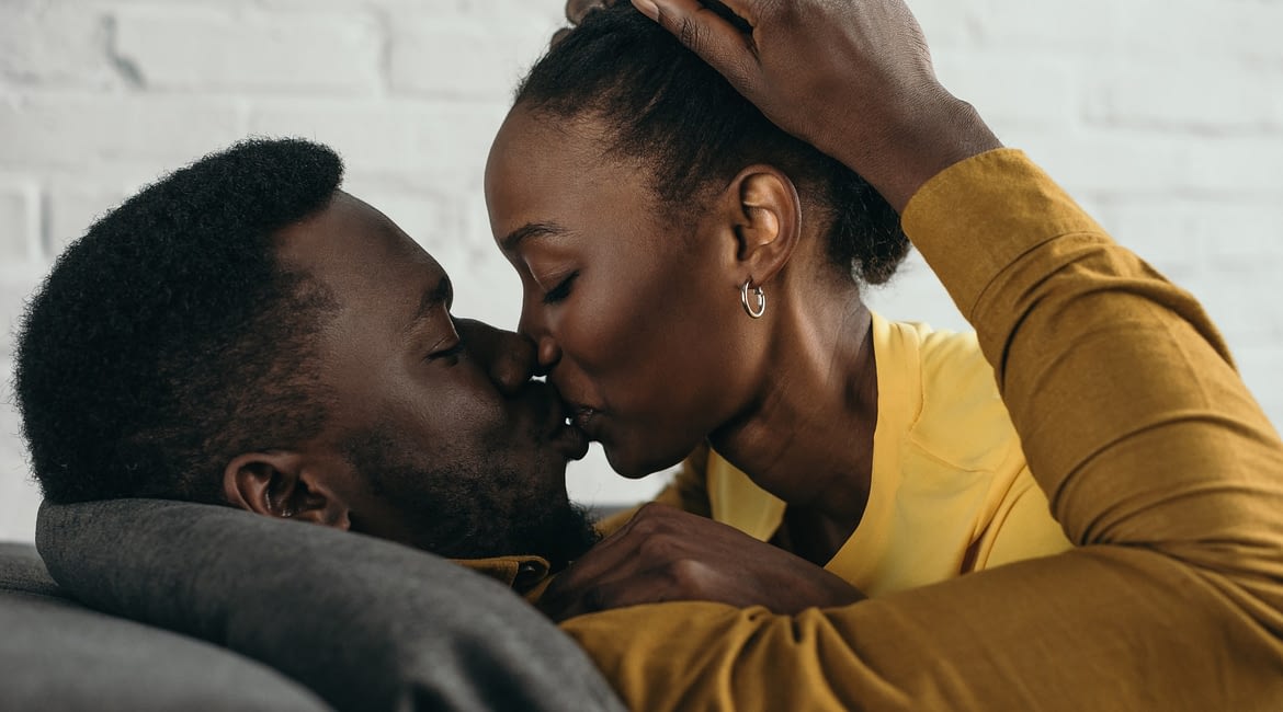beautiful young african american couple kissing at home revive your romance with a four-letter word Revive Your Romance with a Four-Letter Word beautiful young african american couple kissing at home 1170x650